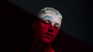 The Late Lil Peep In A Striking Red Aesthetic Portrait Wallpaper