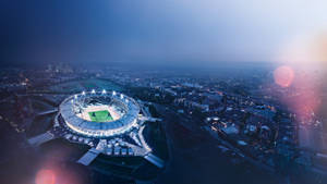 The Lights Come Alive As The Olympics Stadium Competes With The Stars Above Wallpaper