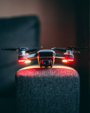 The New Age Of Technology: A Drone On An Armchair Wallpaper