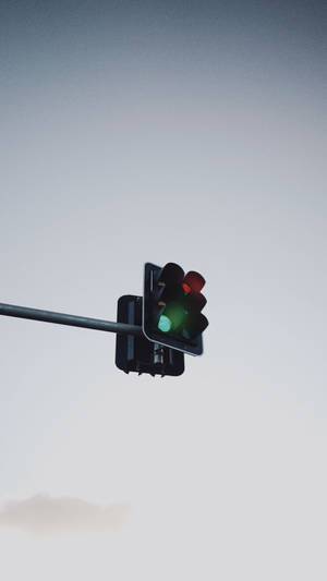 The Perfect Green Hues Of A Traffic Light Against A Bright Blue Sky Wallpaper