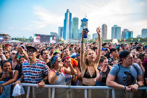 Thousands Of Fans Having A Great Time Enjoying The Music At Lollapalooza In Chicago Wallpaper