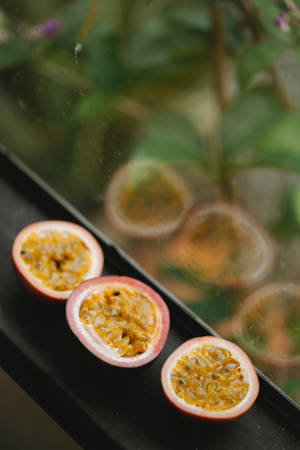 Three Sliced Passion Fruit By The Window Wallpaper