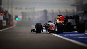 Thrilling Speed - F1 Racing Car Tearing Up The Track Wallpaper