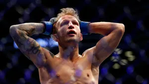 Tj Dillashaw Holding His Head Wallpaper