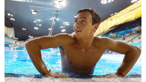 Tom Daley Preparing For A Dive At The Pool Side. Wallpaper
