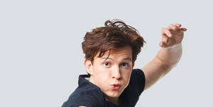 Tom Holland Striking A Casual Pose Wallpaper
