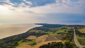 Top View Of Plaid Field And Ocean Wallpaper