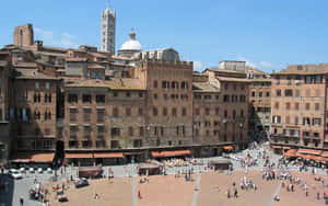 Tourist Visiting Piazza Del Campo In Siena Wallpaper