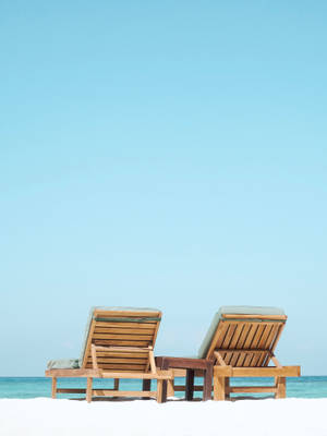 Tranquil Beach Loungers Awaiting Visitors Wallpaper