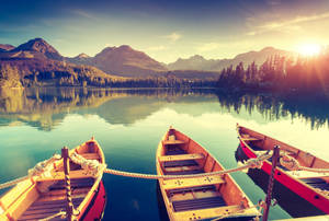 Tranquil Lake Boat Ride At Dusk Wallpaper