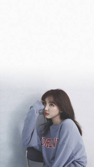 Twice Nayeon Sitting On A Chair Wallpaper