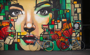 Two Blue Cruiser Bicycles On Graffiti Wall Wallpaper