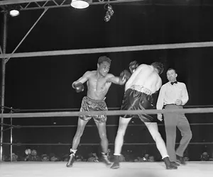 Two Boxers In A Ring With A Referee Wallpaper