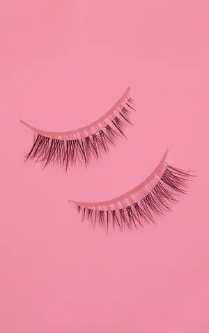 Two False Eyelashes On A Pink Background Wallpaper