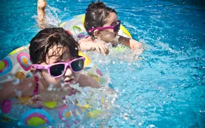 Two Little Girls In Swimming Pool Wallpaper