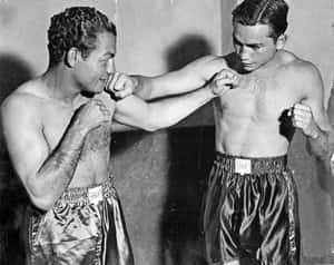 Two Men In Boxing Shorts Are Preparing For A Fight Wallpaper