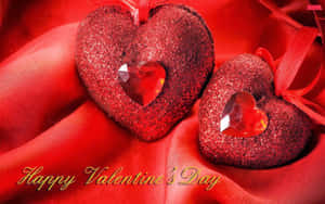Two Red Hearts With Happy Valentine's Day Written On Them Wallpaper