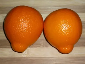 Two Tangelo Fruits On Chopping Board Wallpaper