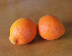 Two Tangelo Fruits On Wooden Table Wallpaper