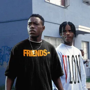 Two Young Men Standing Next To Each Other Wallpaper