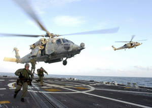 U S Navy Helicopter Landing On A Carrier Wallpaper