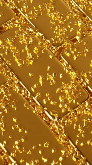 Unbox A Stunning Gold Iphone And Keep The Gold-themed Glamour Going. Wallpaper