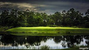 Under The Cloud-covered Sky - The Resplendent Golf Course Wallpaper