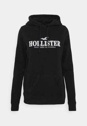 Unleash Your Street Style With Hollister's Black Hoodie Jacket Wallpaper