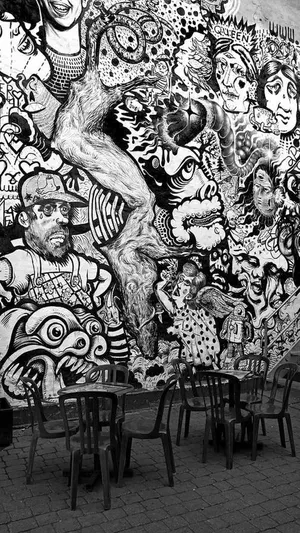 Urban Artistic Expression In Black And White Graffiti Wallpaper