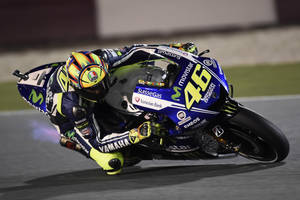 Valentino Rossi, The Legendary Motogp Racer In Action Wallpaper