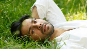 Varun Dhawan On The Grass Wallpaper