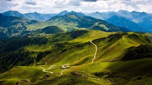 Verdant Alpine Valley Road Wallpaper