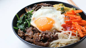 Vibrant And Traditional Korean Bibimbap Dish Wallpaper