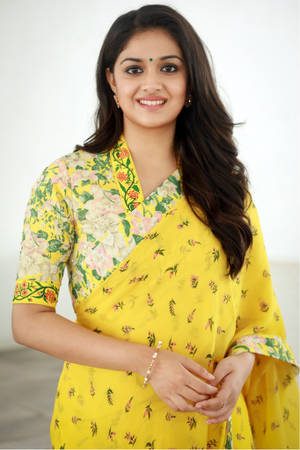 Vibrant Elegance - Keerthi Suresh In A Stunning Yellow Floral Saree Wallpaper