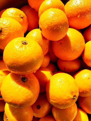 Vibrant Fresh Satsuma Mandarin On A Neutral Background Wallpaper