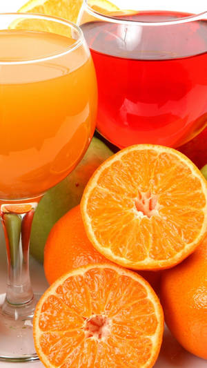 Vibrant Grapefruit Slices And Fresh Juice Wallpaper