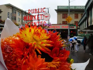 Vibrant Orange Flower Bouquet At Pike Place Market Wallpaper