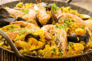 Vibrant Spanish Paella With Premium Seafood Wallpaper