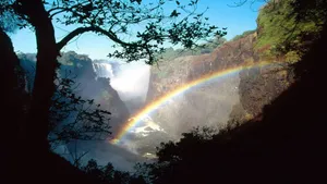 Victoria Falls With A Shining Rainbow Wallpaper