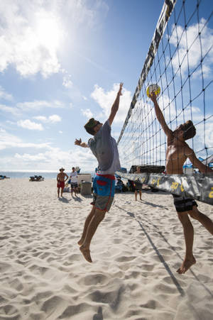 Volleyball Players Colliding At The Center Wallpaper