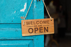 Welcome Sign On Teal Door Wallpaper