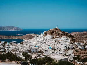 White And Brown Houses Near Body Of Water During Daytime Wallpaper