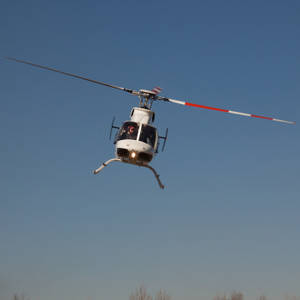 White Helicopter Tilted Flying Wallpaper