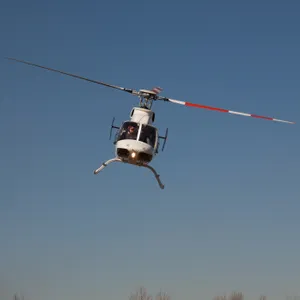 White Helicopter Tilted Flying Wallpaper