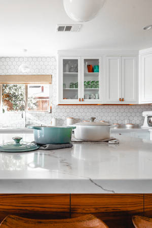 White Marble Tabletop With Wooden Base In The Kitchen Wallpaper