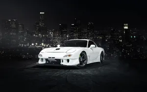 White Mazda Rx7 Overlooking City Wallpaper