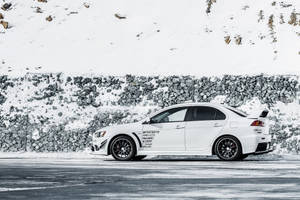 White Mitsubishi Lancer Conquering Snow Wallpaper