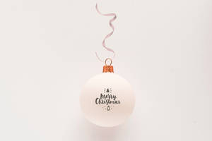 White Ornament With Merry Christmas And Ribbon Wallpaper