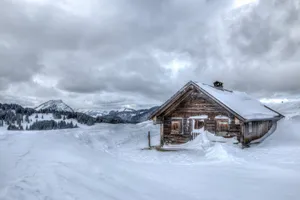 Winter House And Cloudy Skies Wallpaper