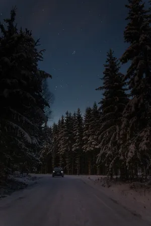 Winter Night Desktop With A Car Driving Wallpaper